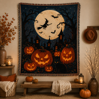 Moonlit witch and pumpkin Halloween woven blanket displayed as seasonal wall decor with fringe