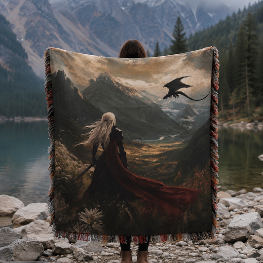 Fantasy dragon woven blanket held open outdoors beside an alpine lake